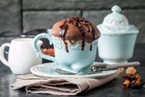 Chocolate,Souffle,With,Chocolate,Glaze,In,A,Cup,On,Grey