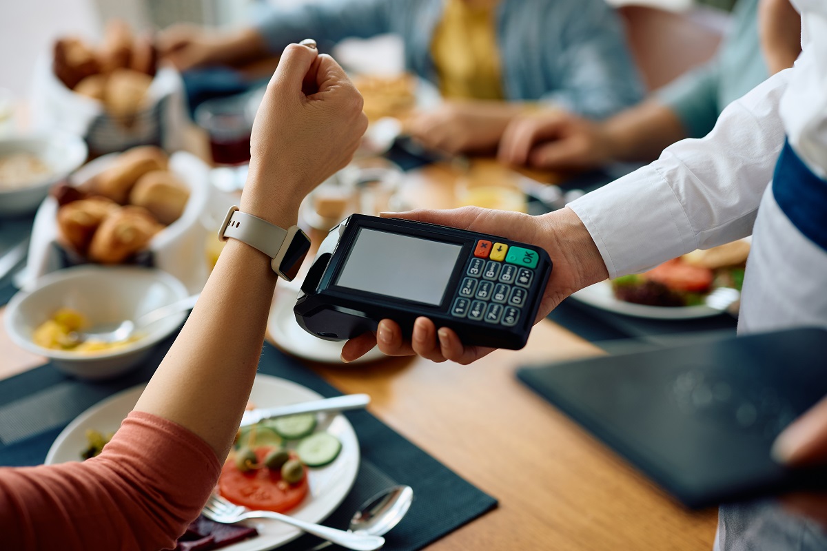 Close,Up,Of,Woman,Paying,With,Her,Smart,Watch,During