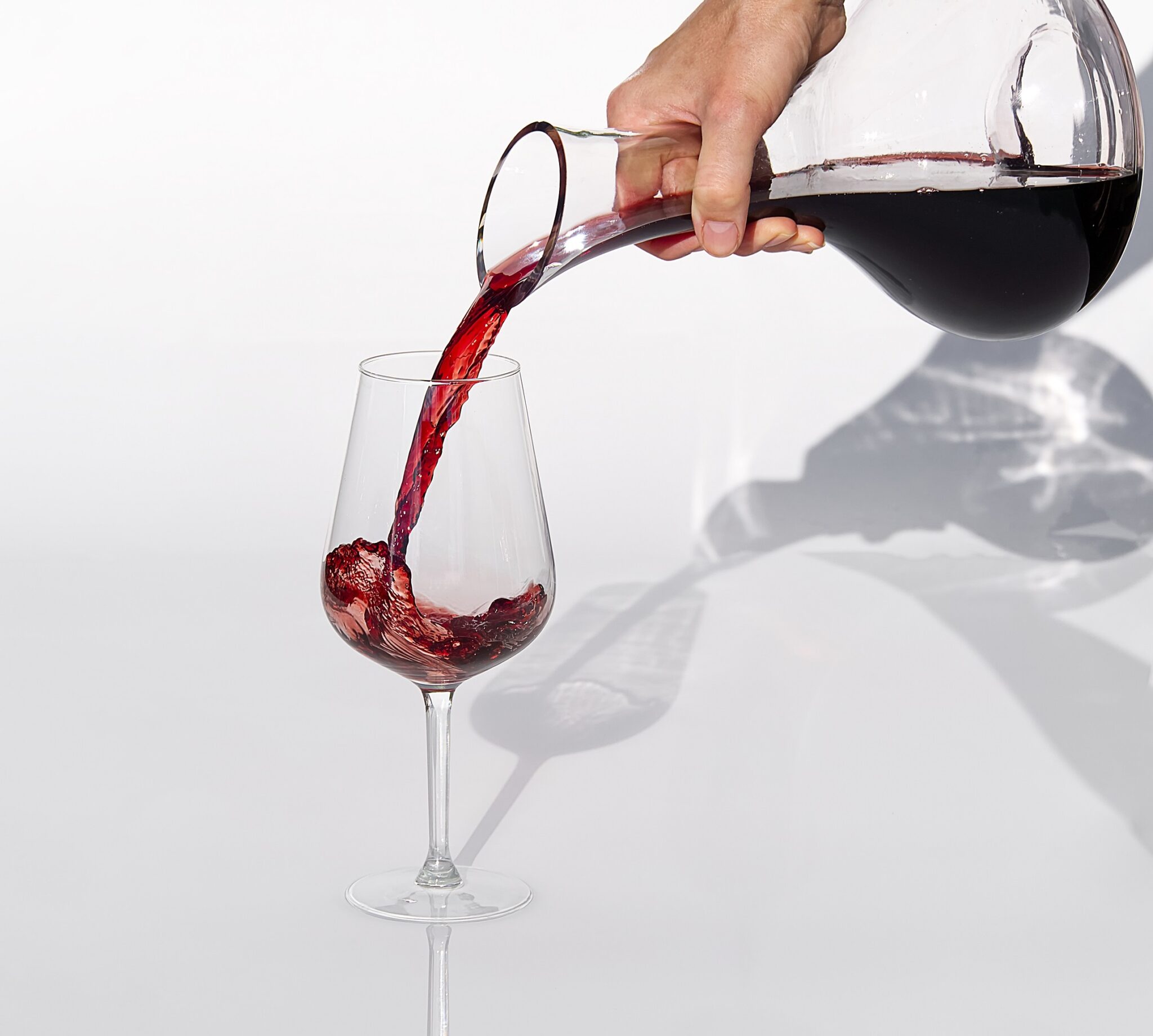 Sommelier,Pours,Red,Wine,From,Decanter,To,Wineglass,On,White