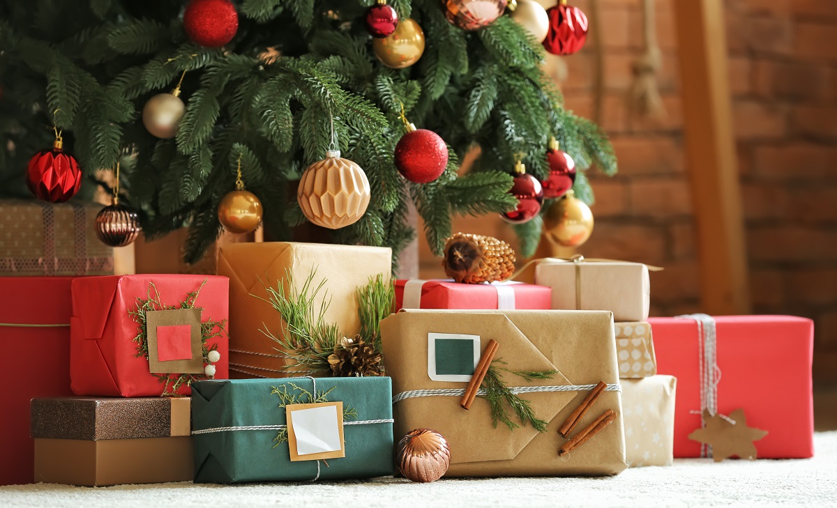 Beautiful,Christmas,Gifts,Under,Fir,Tree,On,Floor,In,Room