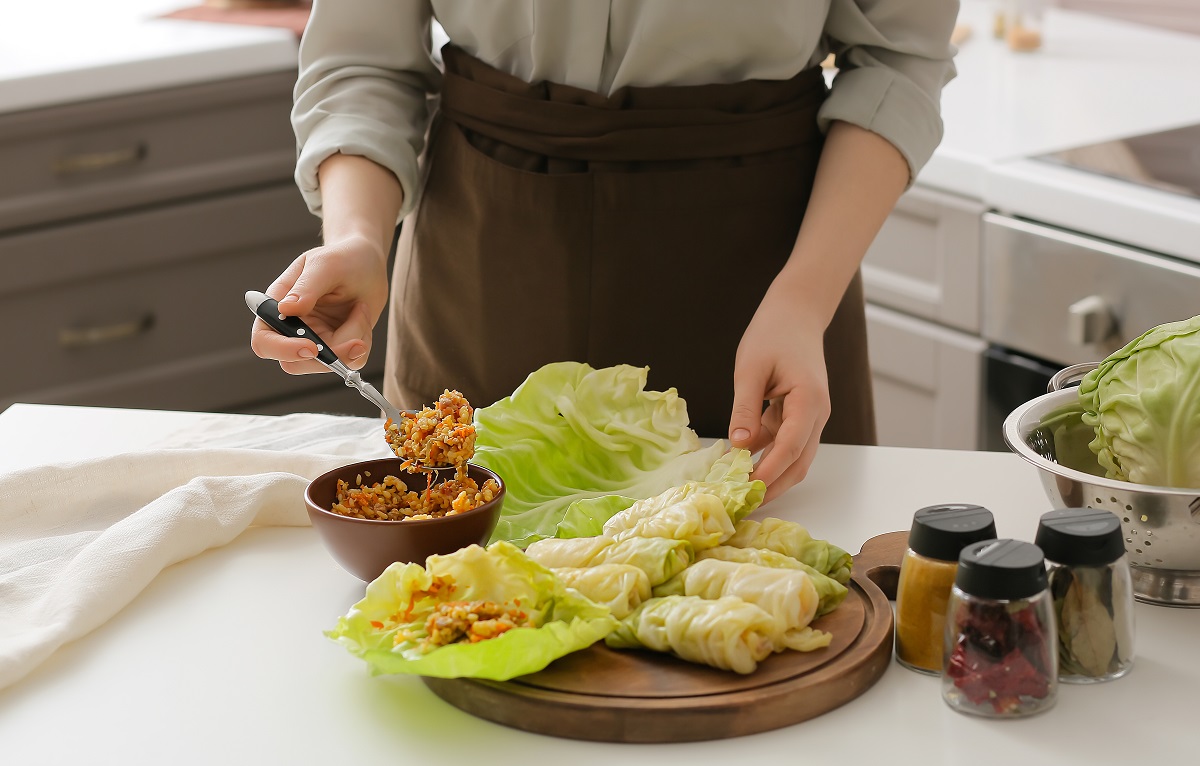 Woman,Preparing,Stuffed,Cabbage,Rolls,On,Table,In,Kitchen,,Closeup