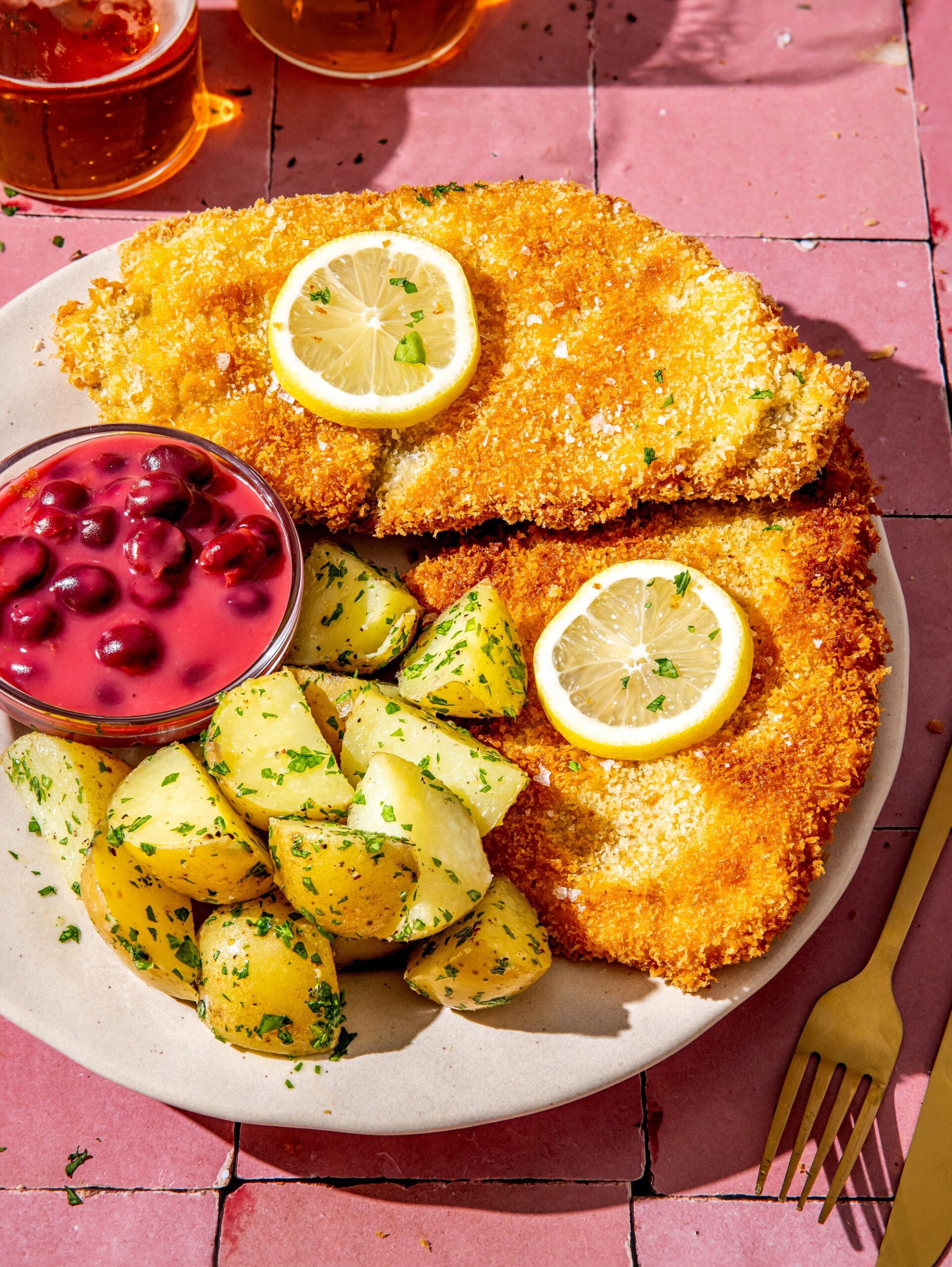 Wiener,Schnitzel,With,Cherry,Sauce,And,Boiled,Potatoes,With,Parsley