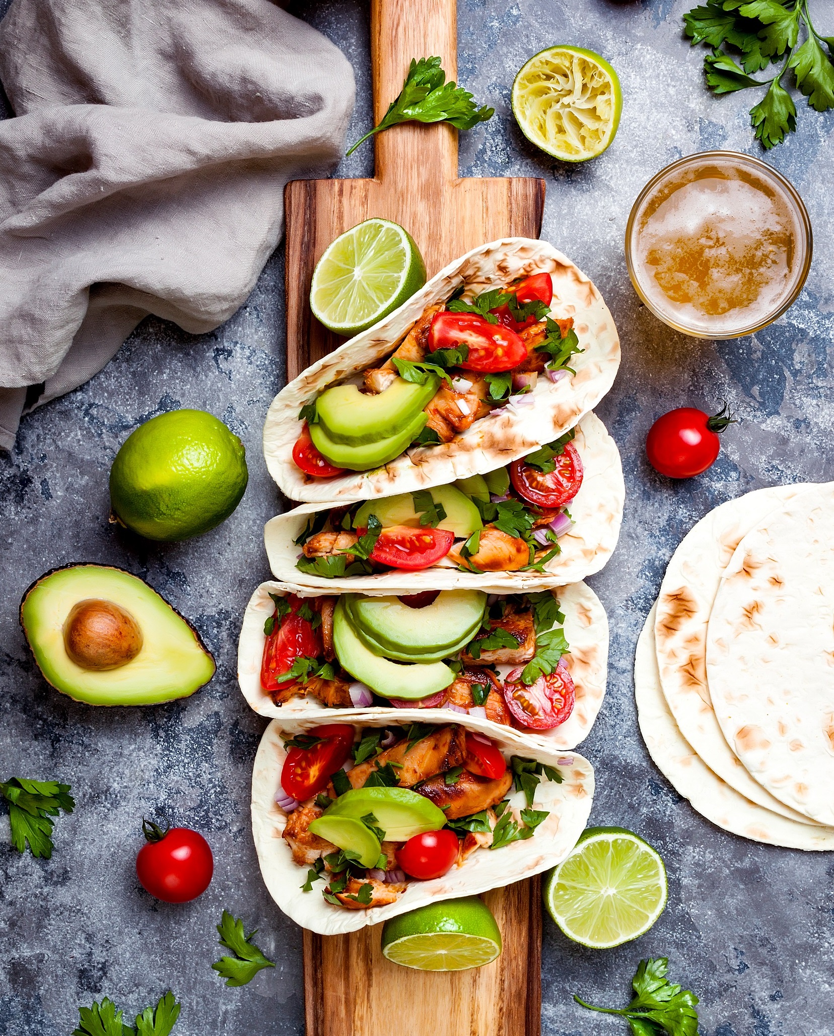 Mexican,Grilled,Chicken,Tacos,With,Avocado,,Tomato,,Onion,On,Rustic