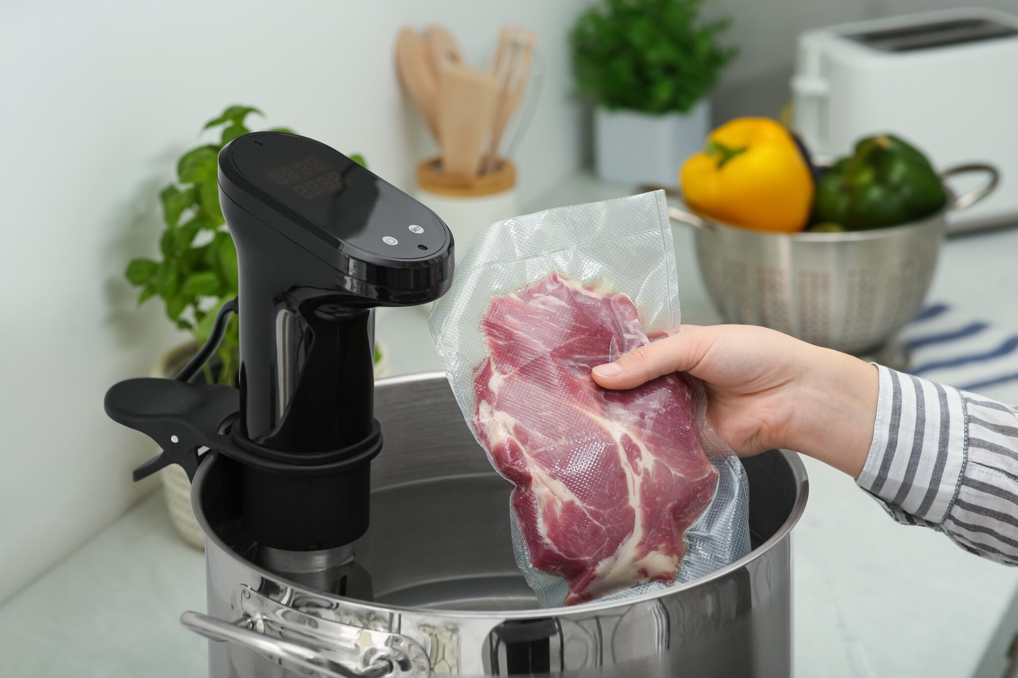 Woman,Putting,Vacuum,Packed,Meat,Into,Pot,In,Kitchen,,Closeup.