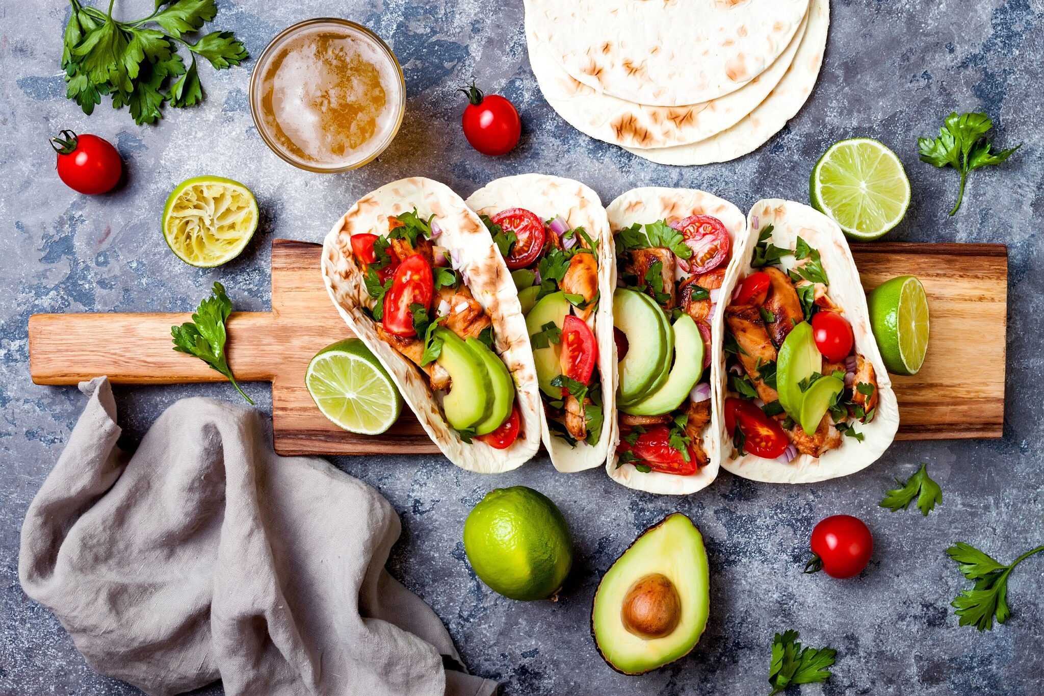 Mexican,Grilled,Chicken,Tacos,With,Avocado,,Tomato,,Onion,On,Rustic