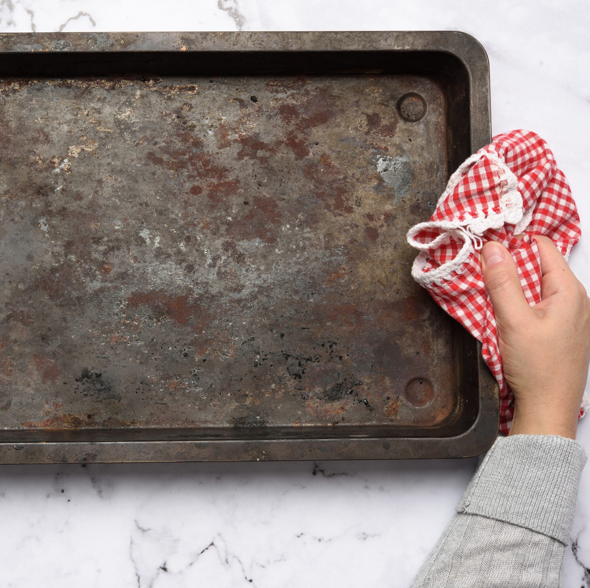 Hand,Hold,Empty,Metal,Rectangular,Baking,Sheet,On,A,White