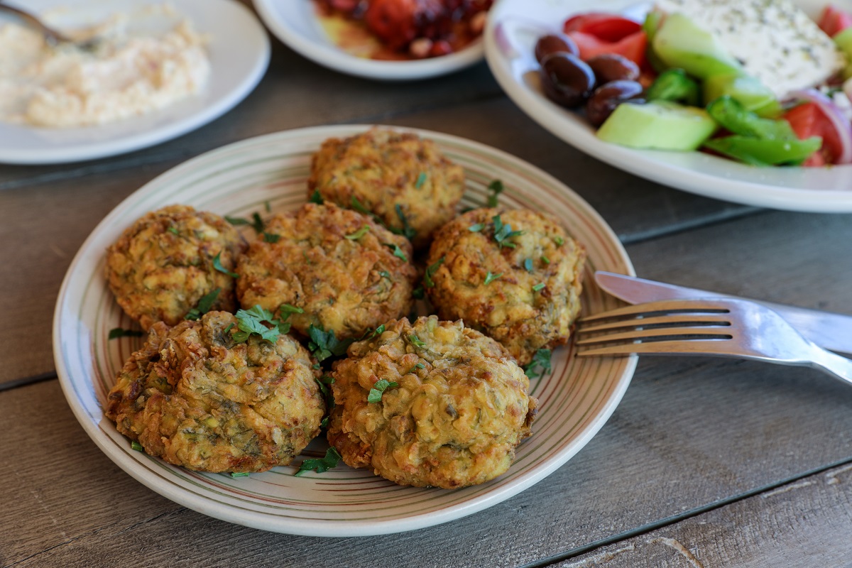 Fried,Zucchini,Balls,Plate,Near,Greek,Salad,Dish,,Snacks,On
