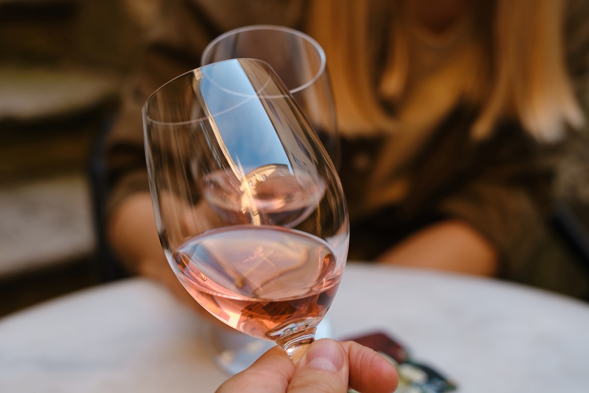 A,Glasses,Of,Rose,Wine,In,The,Hands,Of,A