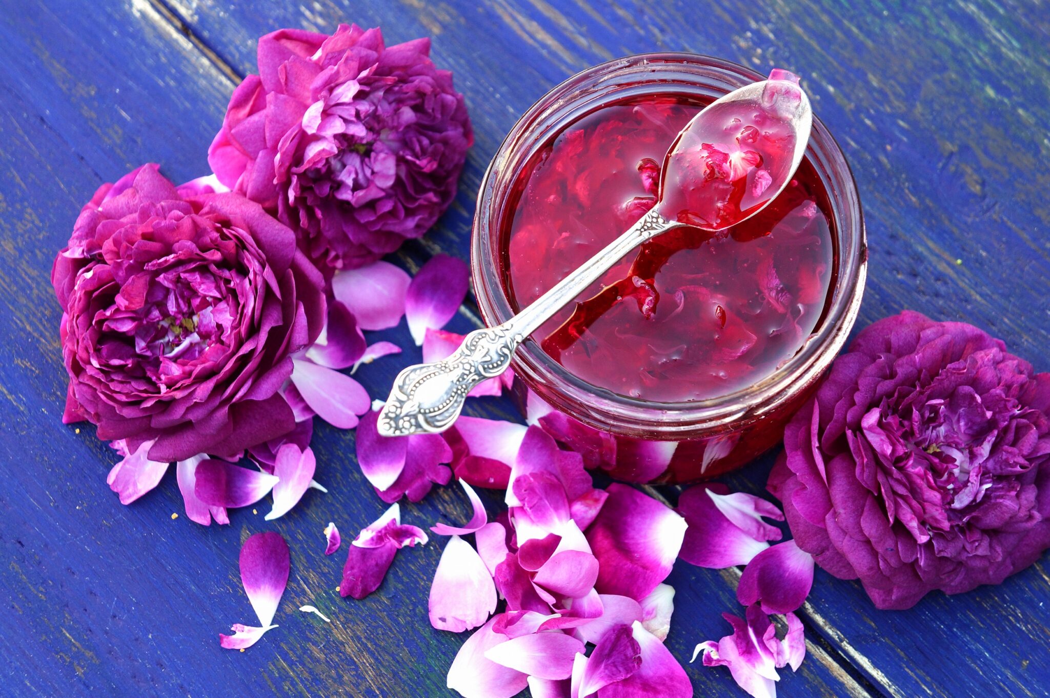 Rose,Petal,Jam,On,Blue,Wooden,Background,In,The,Garden