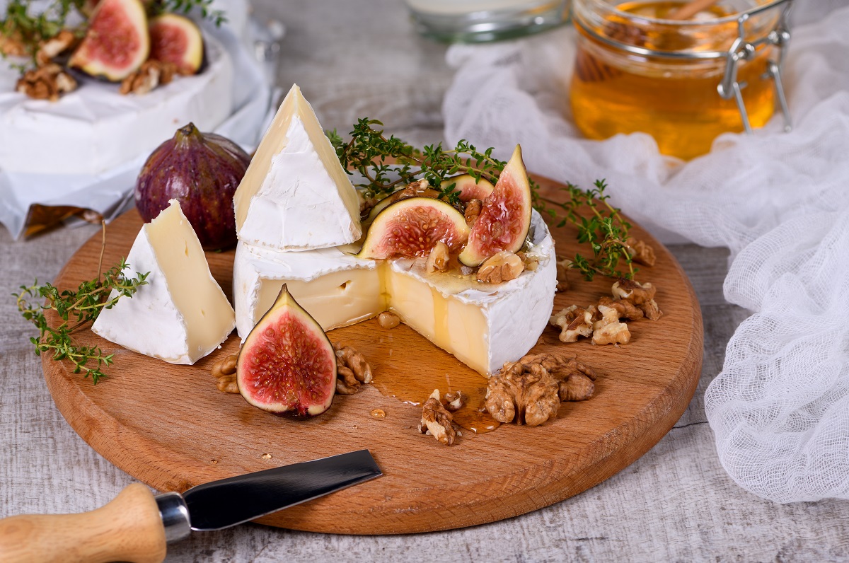 Brie,Cheese,Served,On,A,Wooden,Board,With,Figs,,Walnuts