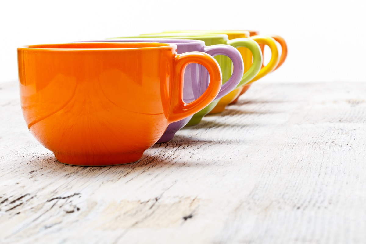 Row,Of,Color,Tea,Cups,On,Old,Wood,Table