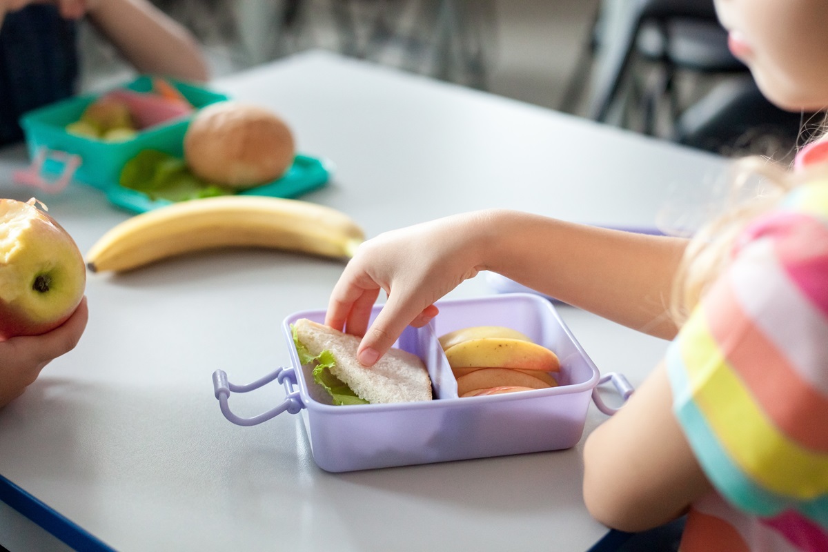 School,Children,Eating,Healthy,Food,From,Packed,Lunch,Boxes.,Kids