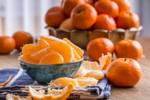 Fresh,Tangerine,And,Segments,On,A,Blue,Tablecloth.