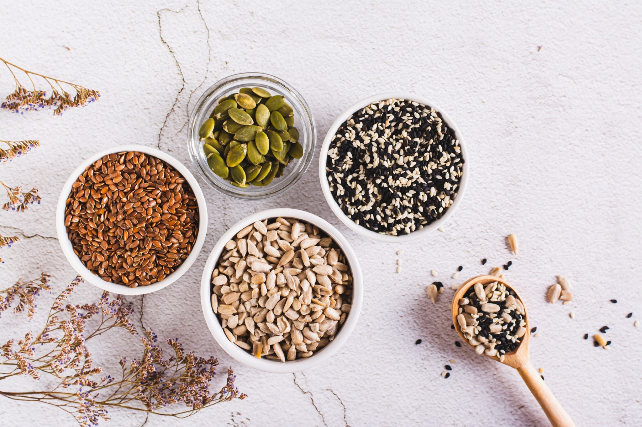 Sesame,,Flax,,Pumpkin,And,Sunflower,Seeds,In,Bowls,And,Spoon