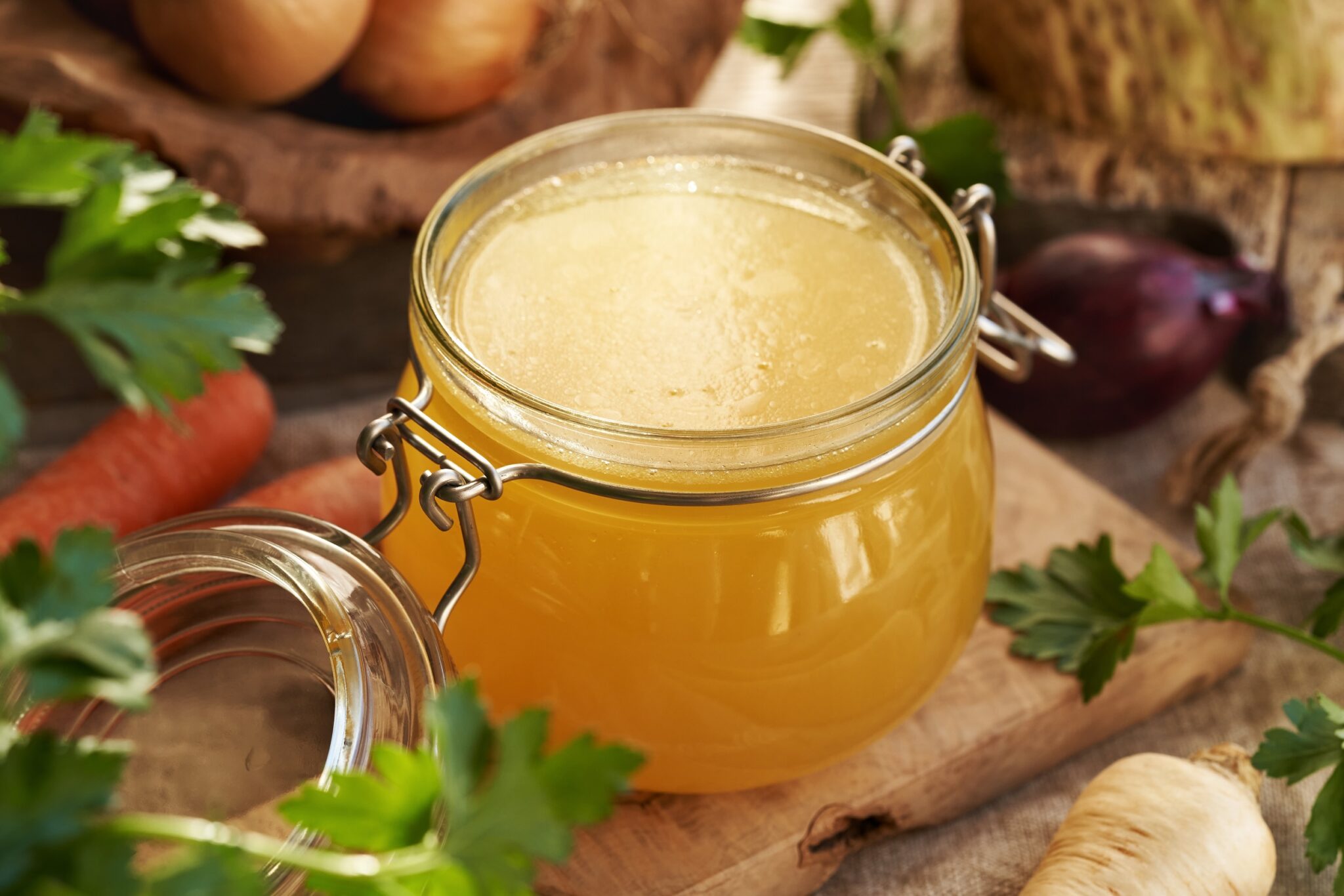 Bone,Broth,In,A,Glass,Jar,With,Fresh,Parsley,,Carrots