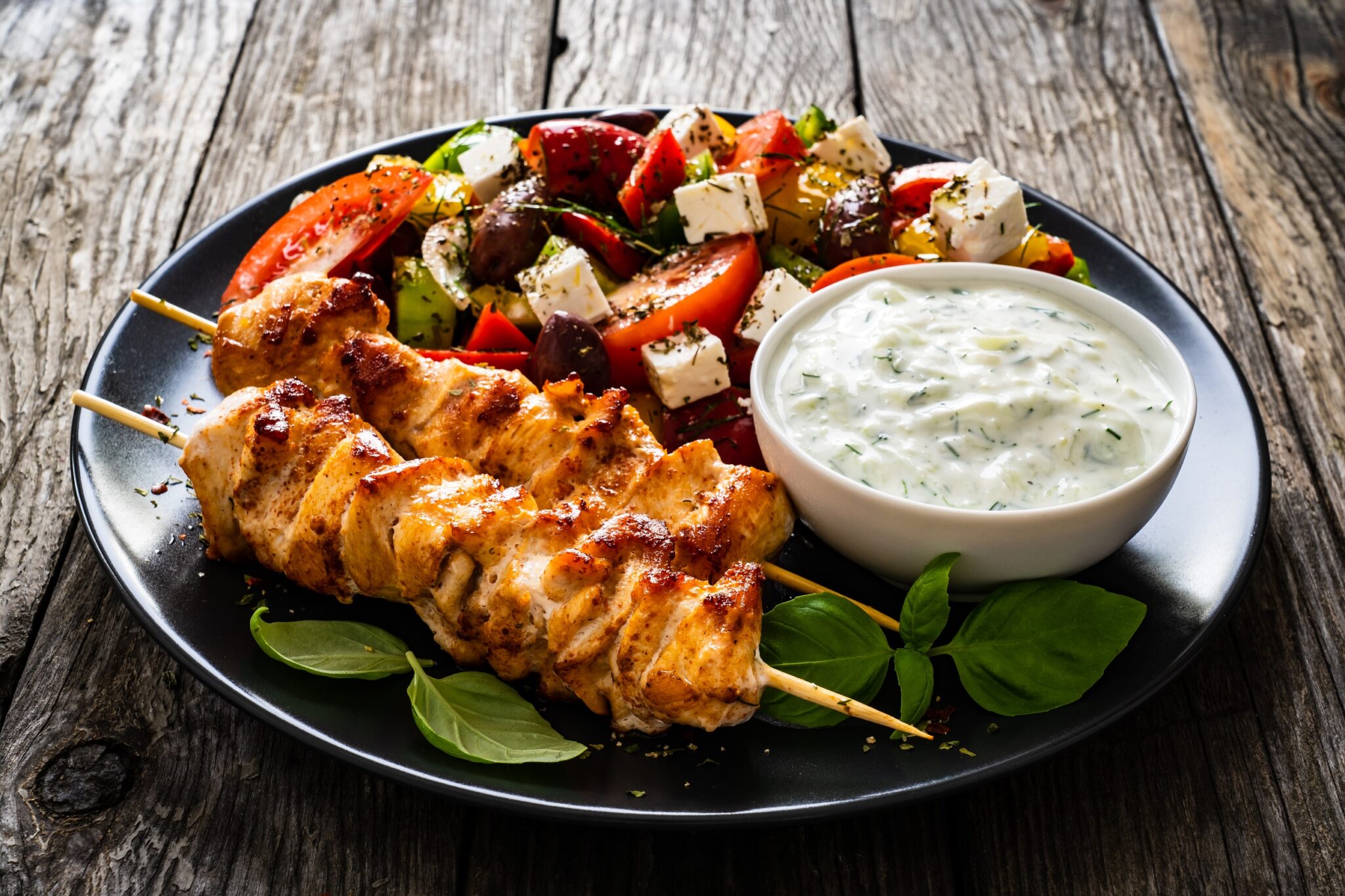 Fried,Souvlaki,,Greek,Salad,And,Tzatziki,On,Wooden,Table