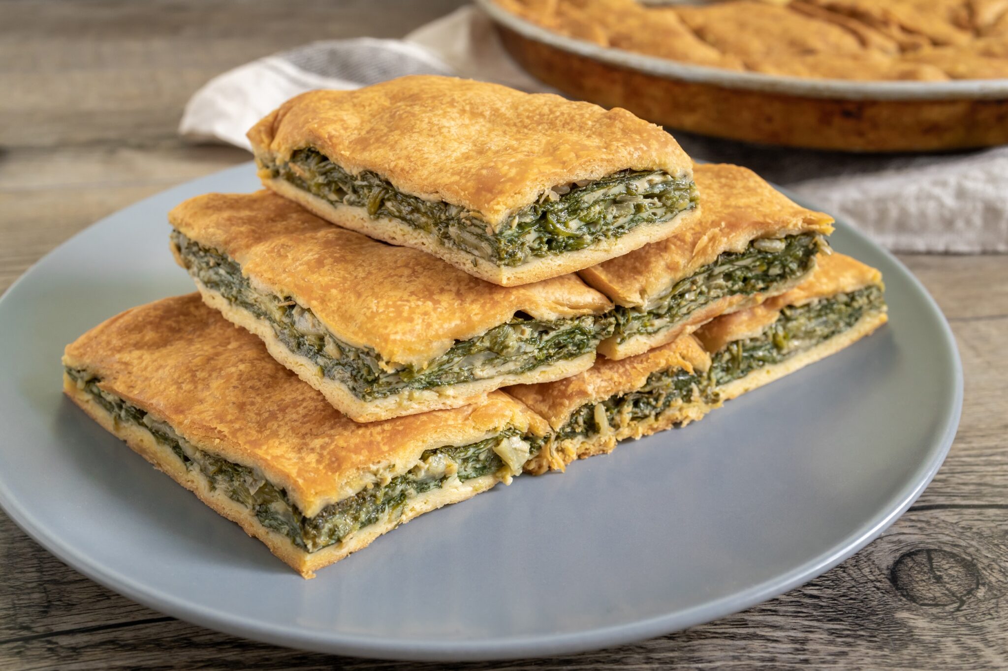Spinach,Pie,Cut,In,Pieces,And,Served,On,A,Plate.