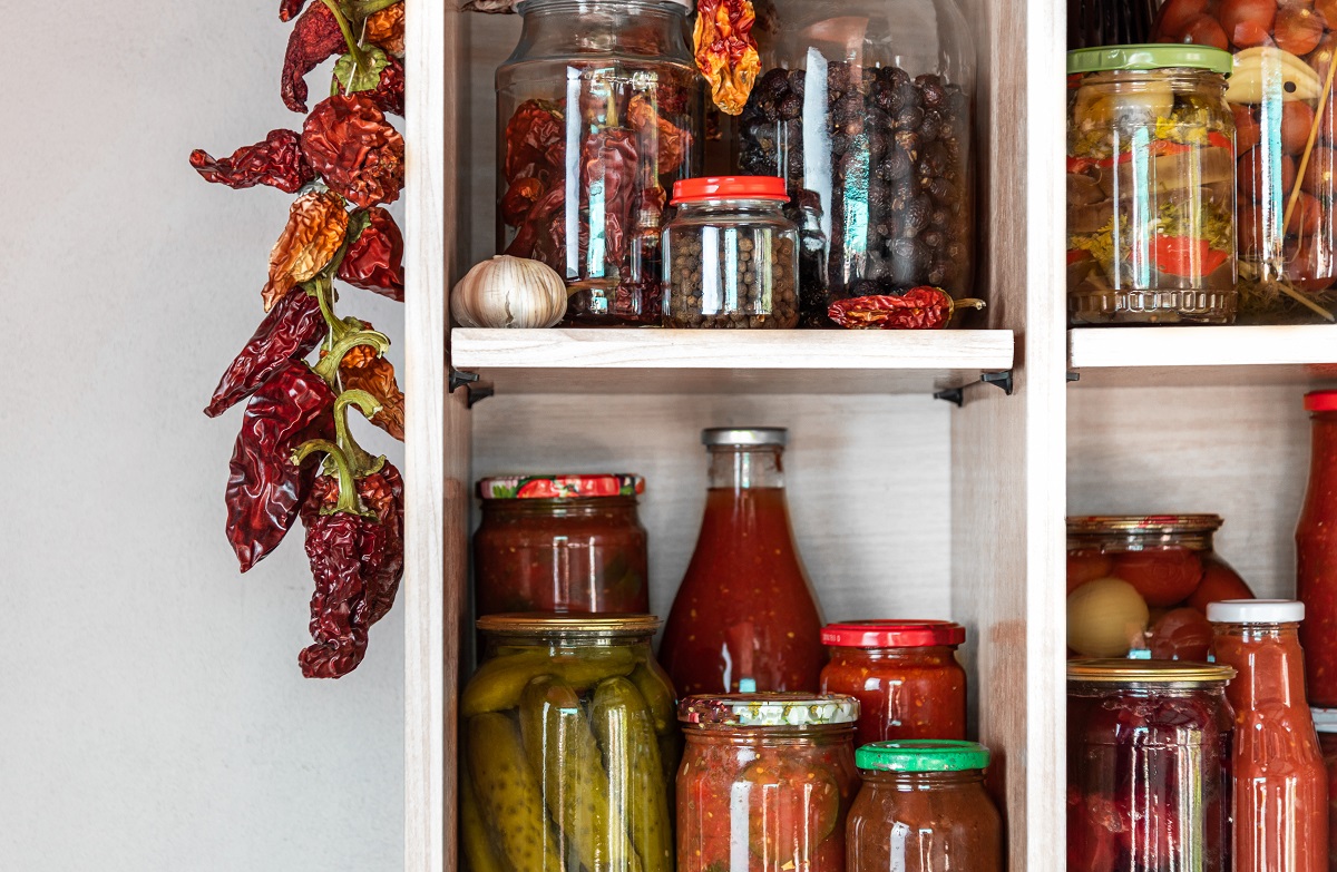 Homemade,Vegetables,,Tomatoes,,Cucumbers,In,Jars,On,Wooden,Shelves,In