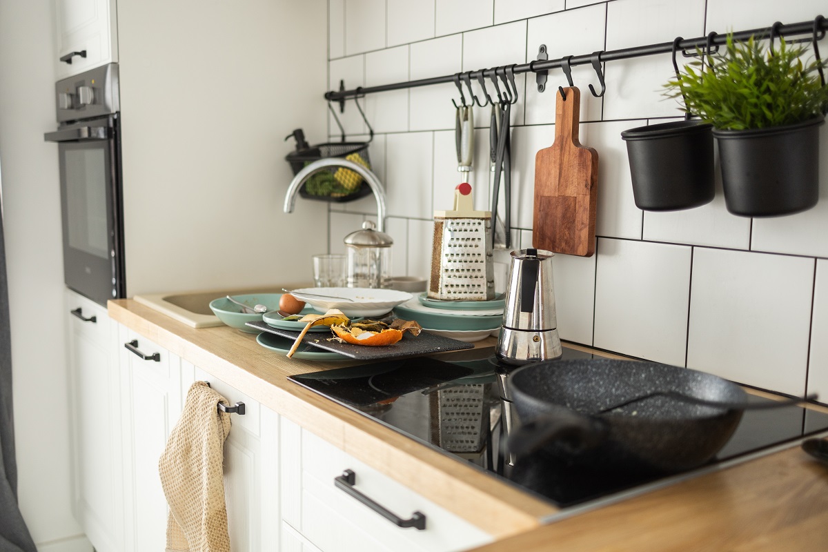 Messy,Kitchen,With,Dirty,Dishes,And,Food,Scraps,On,The