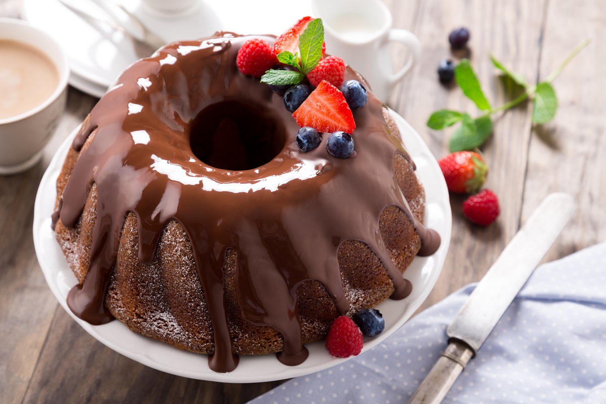 Chocolate,Bundt,Cake,With,Melted,Chocolate,And,Frozen,Berries