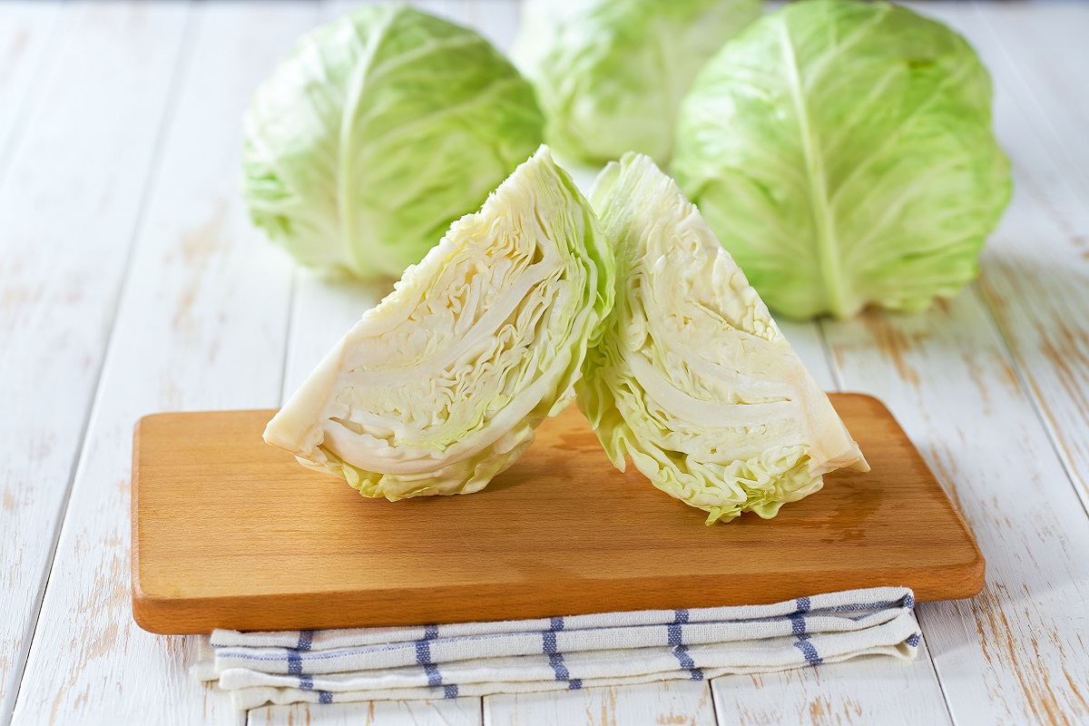 Whole,And,Quarter,Green,Cabbage,On,A,Wooden,Table,