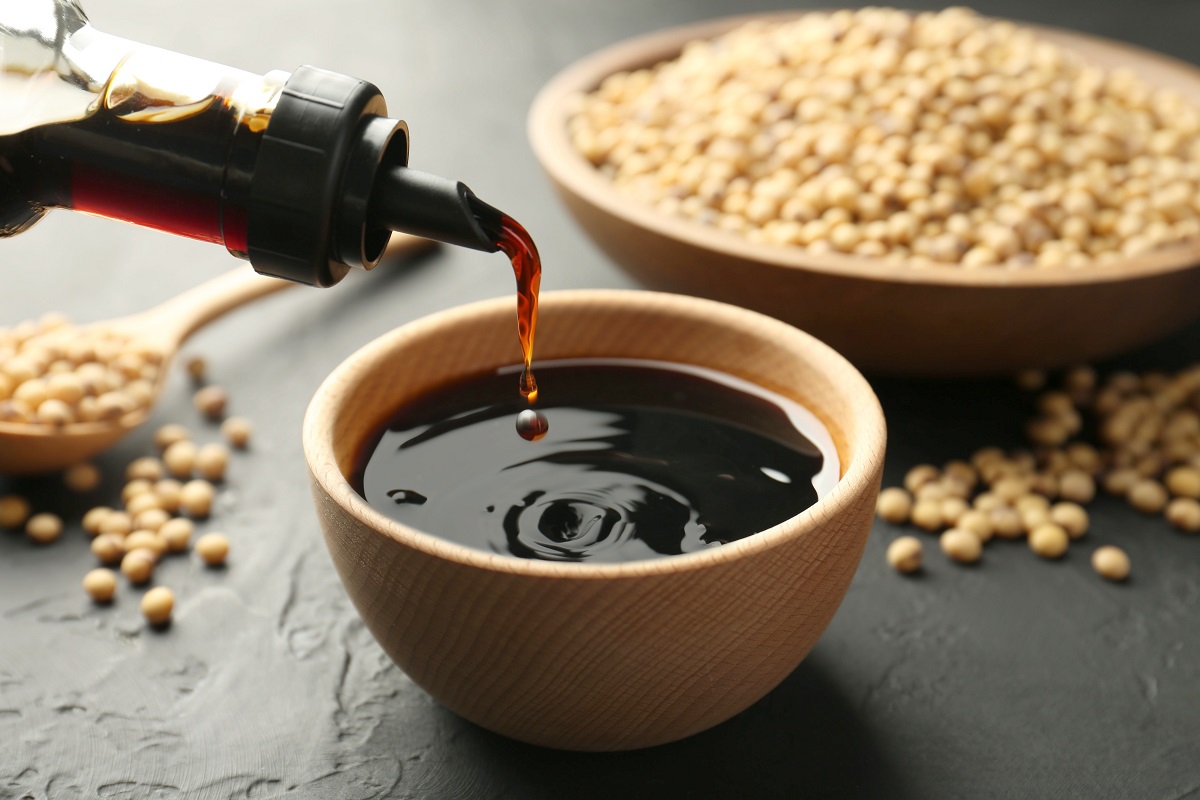 Pouring,Tasty,Soy,Sauce,From,Bottle,Into,Bowl,On,Black