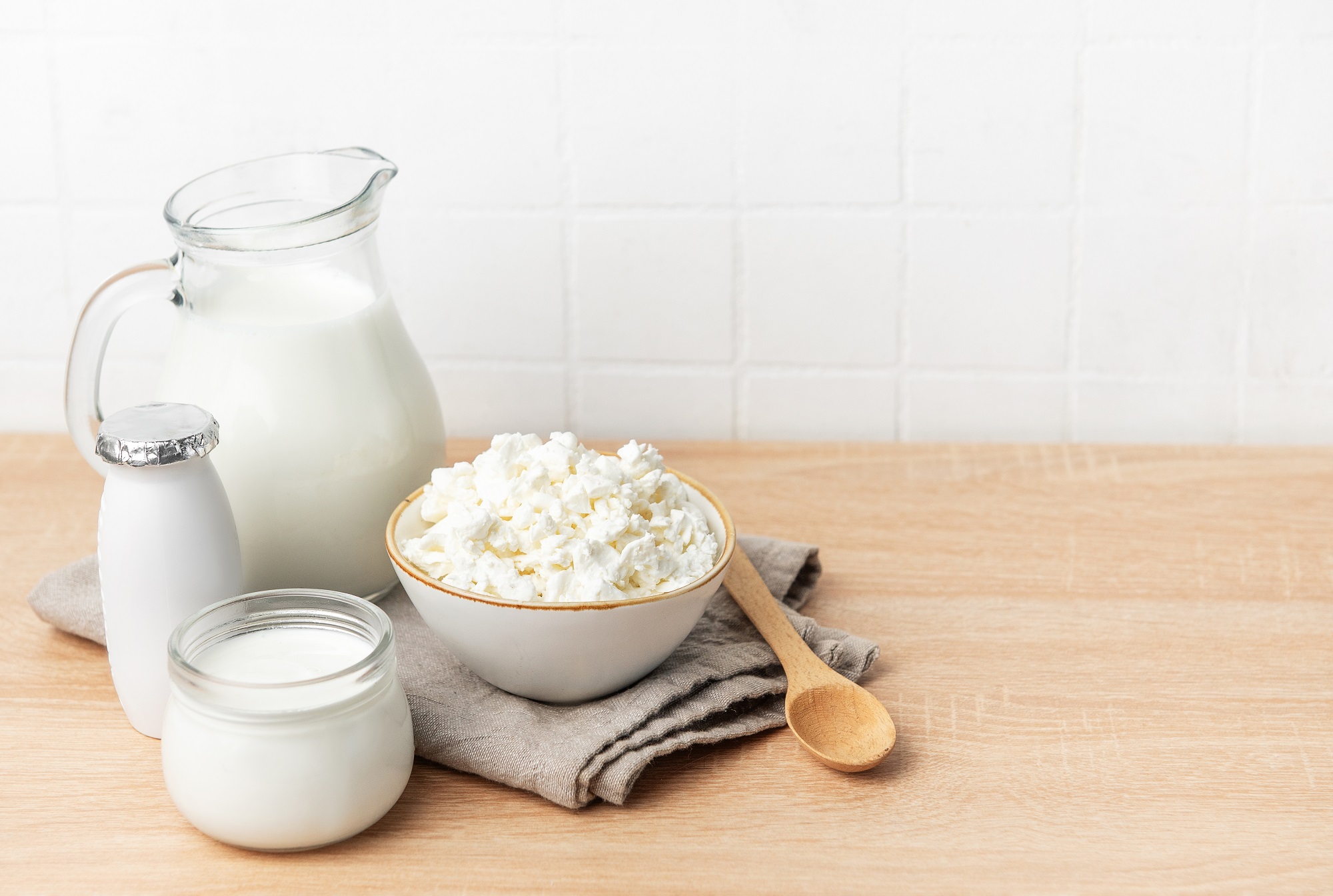 Various,Fresh,Dairy,Products,On,A,Wooden,Counter,With,White