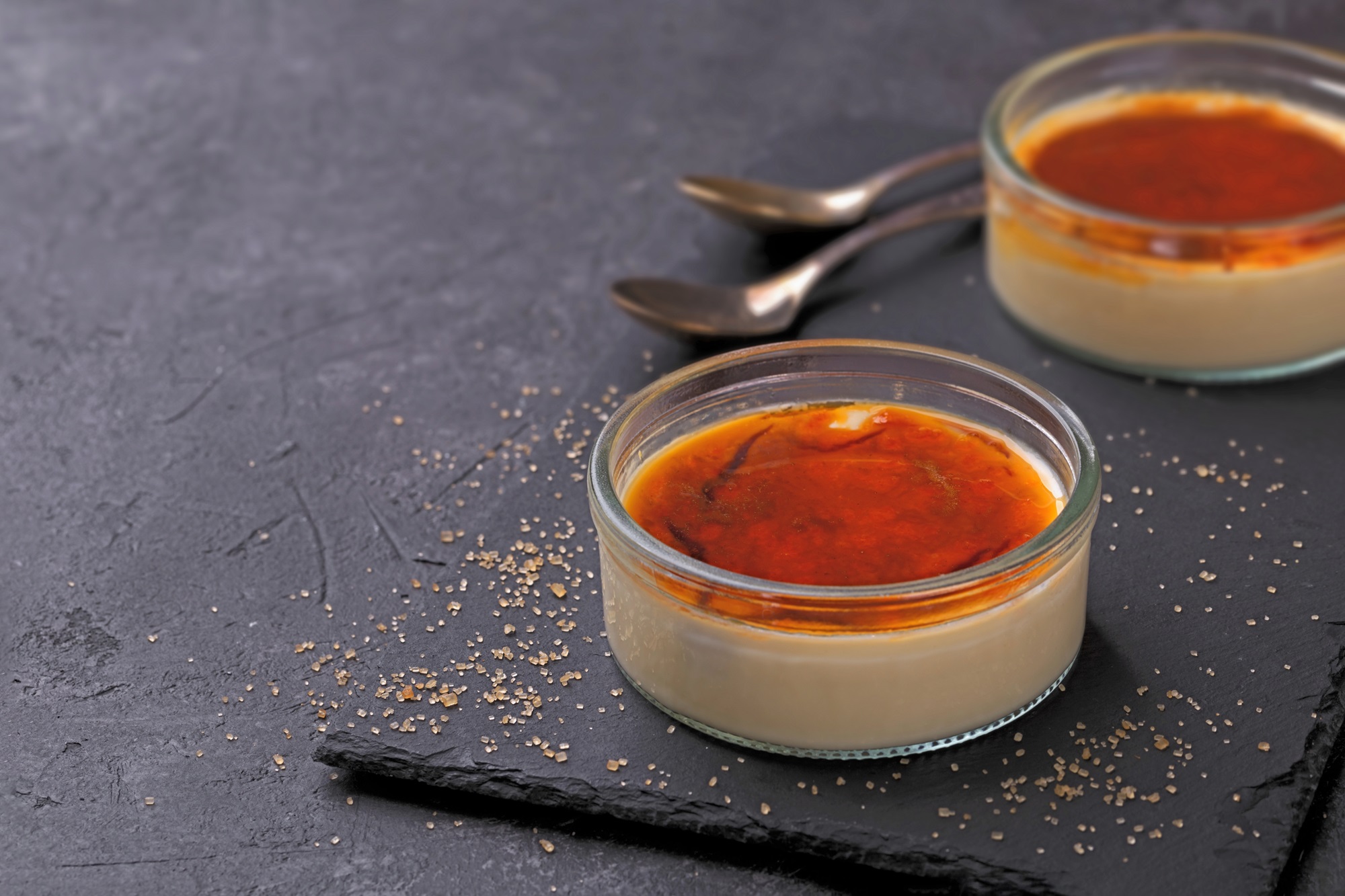 Bowl,Of,Vanilla,Creme,Brule,On,Black,Stone,Background,Traditional
