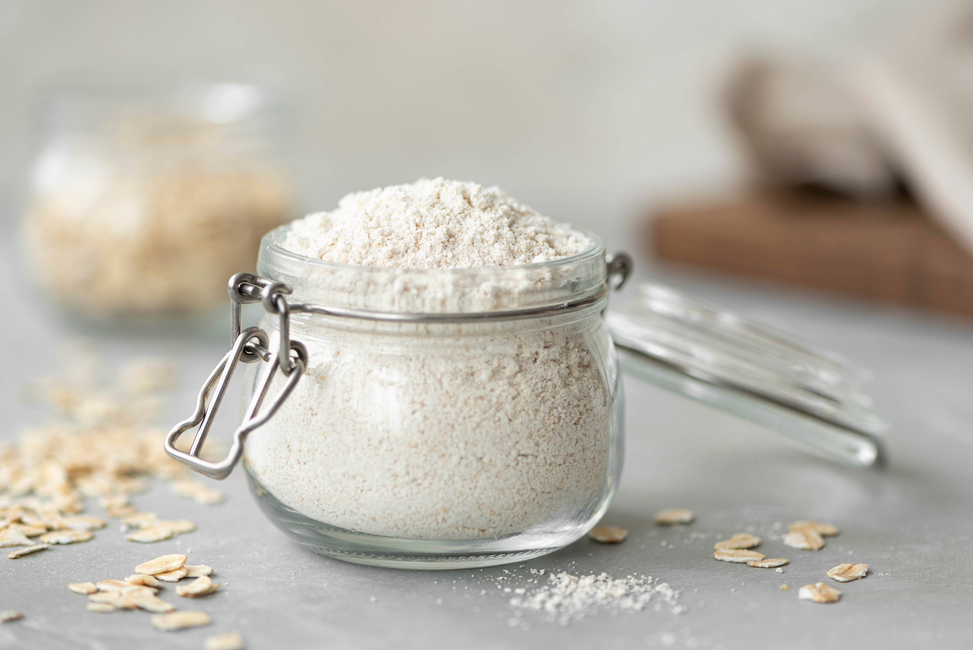 Oat,Flour,In,A,Glass,Jar,On,A,White,Table,